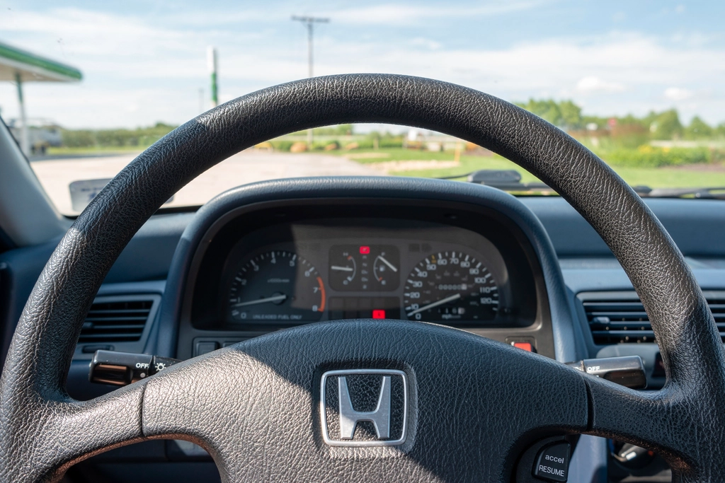 Dashboard and odometer of an older car, since vehicle type and annual mileage affect how car insurance rates are calculated