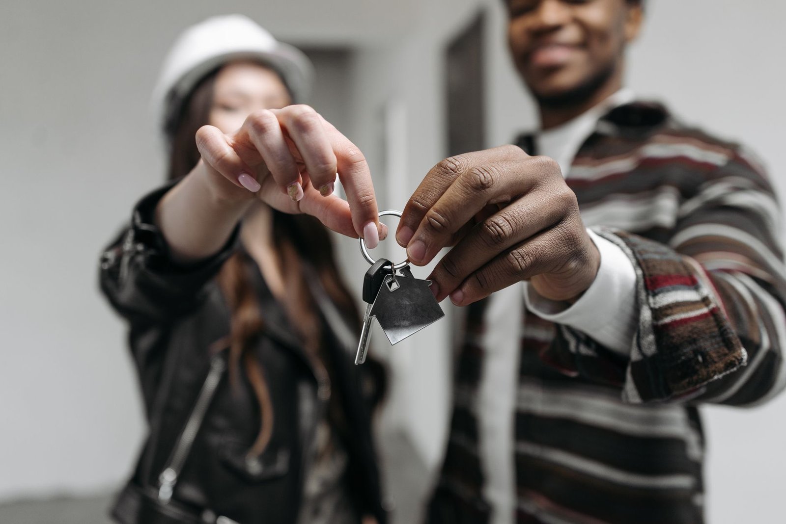 First-time home buyers at their new front door after choosing a loan programme