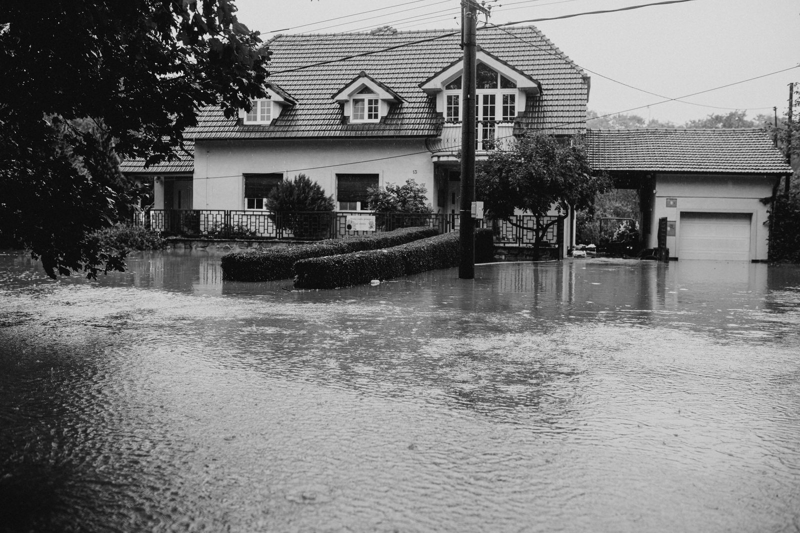 Flooded residential street, because flood damage is excluded from every standard US home insurance policy