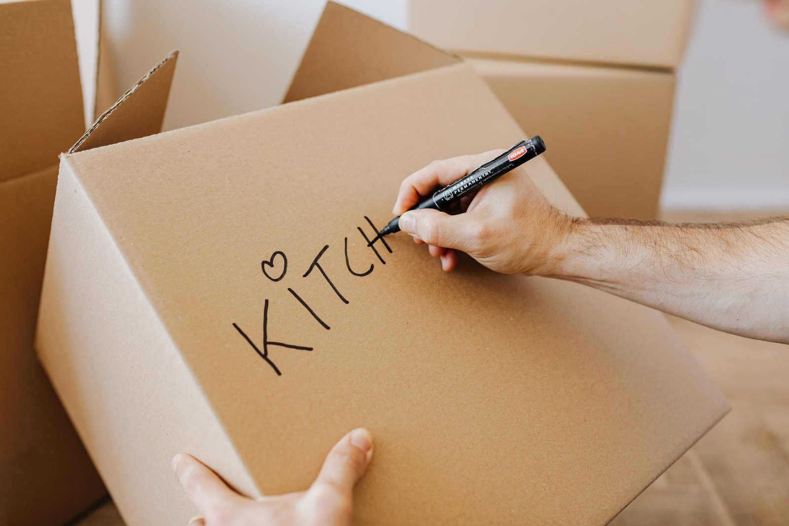 Moving boxes in an apartment, a reminder to photograph belongings for a renters insurance inventory